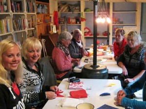 Vrouwen knustelen aan tafel op de kleine camping Gelderland
