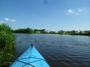 Een punt van een blauwe kano op het water bij de kleine camping Overijssel